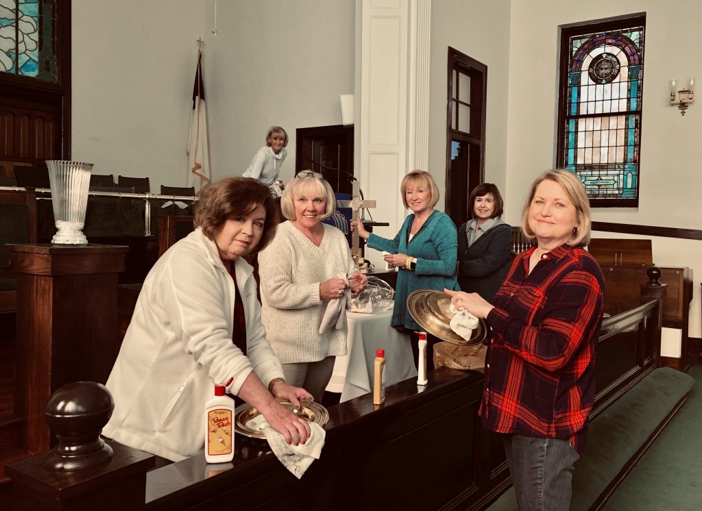 Members of the Beverly Smith Guild polish the altar brass.